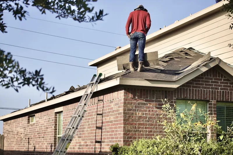 Professional roofer working on a residential roof in Cowtown Park